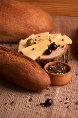Slices of cheese on wooden desk between different breads. place for text