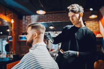 Man with a beard. Hairdresser with a client.