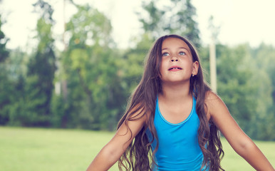 Caucasian little girl with long hair in swimsuit. Happy child