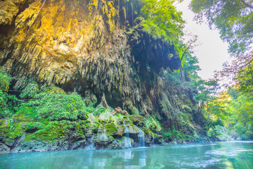 Fototapeta na wymiar river beside the mountain with stalactite rock and small waterfall in the deep tropical rain forest Jungle, Tak province, Thailand