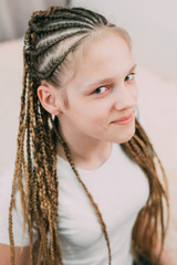 the girl with the brown hair and the braids with kanekalon braided