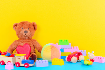 Baby kid toys collection on blue and yellow background