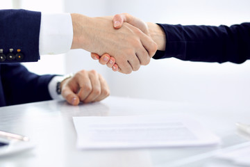 Obraz premium Group of business people or lawyers shaking hands finishing up a meeting , close-up. Success at negotiation and handshake concepts