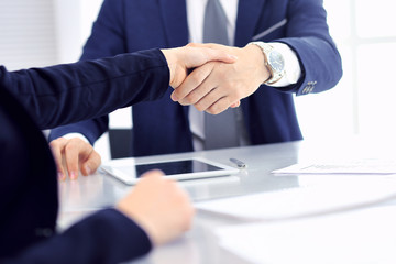 Group of business people or lawyers shaking hands finishing up a meeting , close-up. Success at negotiation and handshake concepts