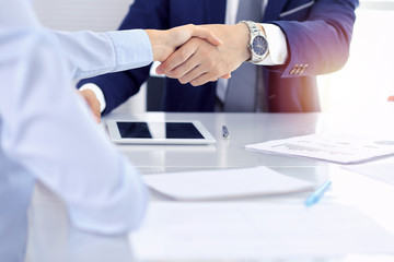 Group of business people or lawyers shaking hands finishing up a meeting , close-up. Success at negotiation and handshake concepts