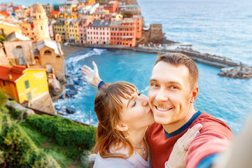 Fototapeta na wymiar Vernazza, national park Cinque Terre, Liguria, Italy, Europe. Tourists happy couple taking selfie photo on camera