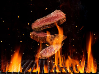 Flying raw beef steaks pieces