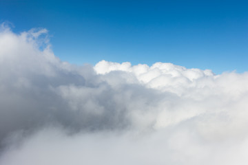 Naklejka na ściany i meble Impressive cloudscape with white clouds beneath