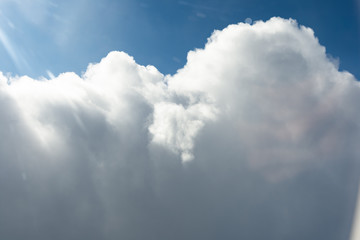 Impressive cloudscape with white clouds beneath