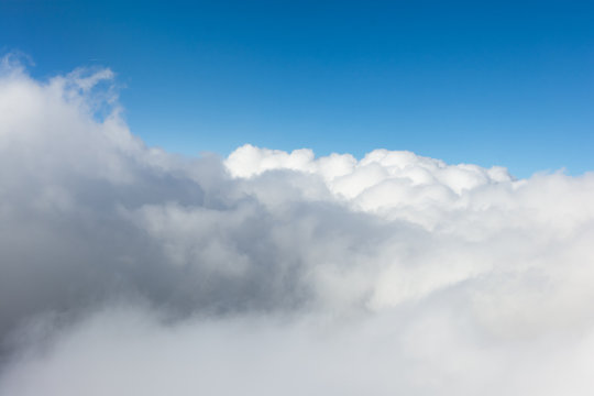 Impressive cloudscape with white clouds beneath
