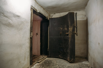 Steel armored door or gate in underground Soviet nuclear military bunker or shelter