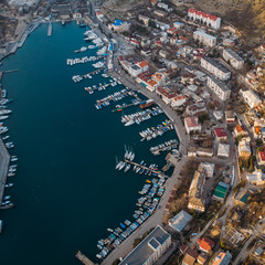 Aerial view of Balaklava landscape with boats and sea in marina bay and small town. Drone  top view shot of port for luxury yachts, boats and sailboats