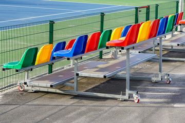 Fototapeta premium portable small size metal stands with colorful plastic seats for spectators