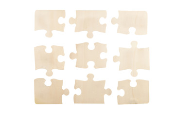 Pieces of wooden jigsaw puzzle isolated on white background. Top view.