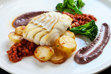 Cod loin with black olives puree and sundried tomatoes