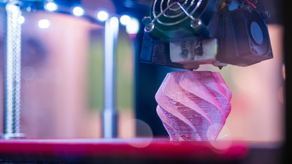 Print head of 3D printer machine printing plastic model at modern scifi technology exhibition. 3D...