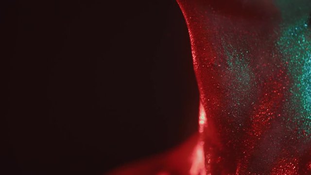 Fashion portrait of woman in glitter and under neon lights in 80's style, video portrait with green and red mixed neon on dark background, Shot in high quality prores 422 on Blackmagic Ursa