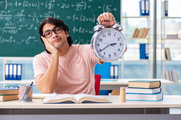 Young male student in the classroom 