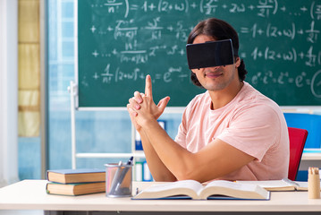 Young male student in the classroom 