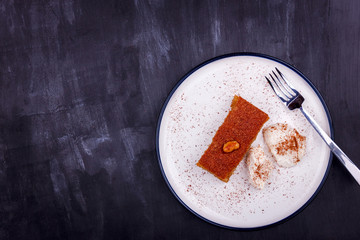 Traditional Turkish dessert - sambali, sambaba or damascus with cream and cinnamon powder