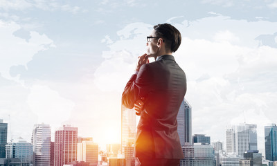 Concept of business success and control with confident boss against cityscape background