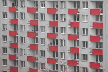 Windows of an apartment building, symmetrical frames in a gray house. many rooms in one house. modern housing construction.