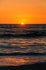 Sunset and waves in Pacific Ocean at Thousand Steps Beach, in Laguna Beach, Orange County, California