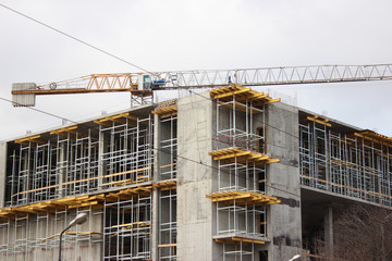 the destruction of the old building, reconstruction, structural changes. construction, high-rise crane works on the site. the building is made of brick, tiles on the walls. installation,