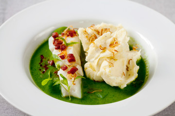 Butter poached cod with green peas, spinach and basil veloute, crispy chorizo and shallot