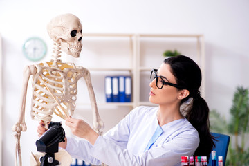 Young female archaeologist working in the lab 