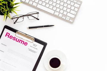Looking for work concept with cv on desk near keyboard, coffee, and glasses white background top view