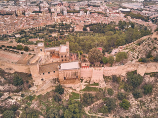 Fototapeta na wymiar Aerial view of the castle of Xativa with the town in the background on a day with blue sky and clouds