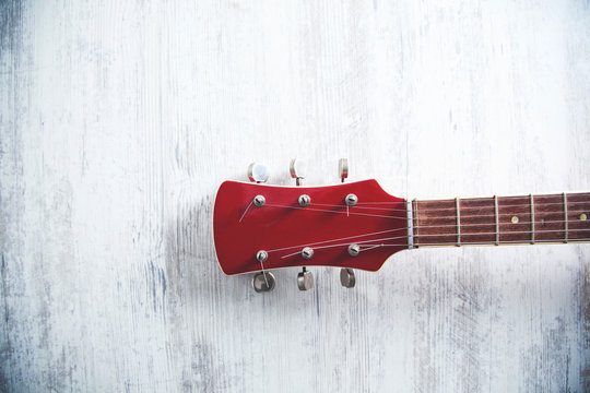 red guitar on desk - Powered by Adobe