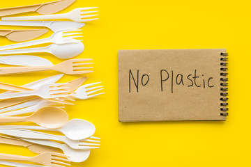 No plastic copy. Eco concept and injunction on the use of plastic flatware on yellow background top...