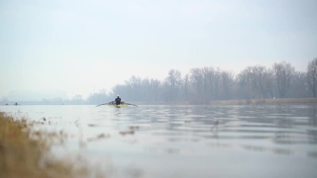Image of man rowing alone at an artificial lake, Zagreb, Croatia.