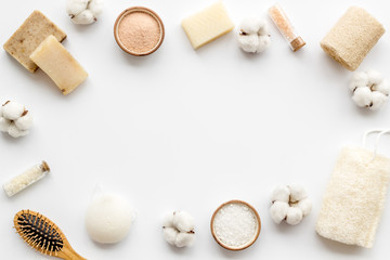 Zero waste set with cosmetics for spa and cotton materials on white background top view copyspace