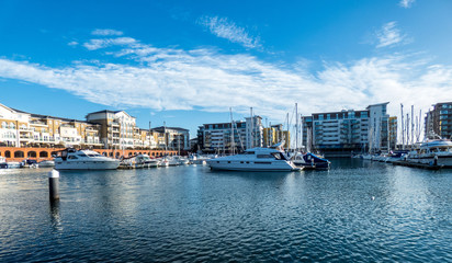 Fototapeta premium Harbour in Eastbourne with yahts, blue sky and water
