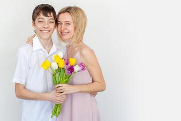 Son gives mom a bouquet of flowers for the holiday