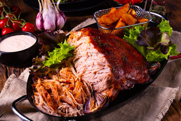 delicious pulled pork with baked potato quarters