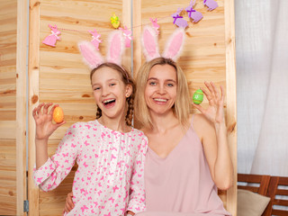 Child and mom holding a basket with Easter eggs