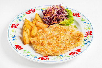schnitzel and fried potatoes on plate