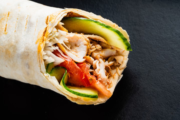 fajita wrap sandwich on the black background