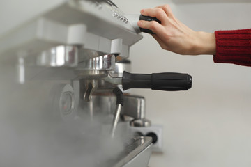 Barista drops off preasure steam from coffee machine
