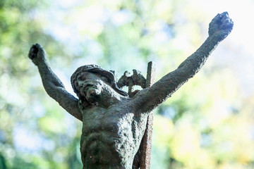Destroyed ancient iron statue of the crucifixion of Jesus Christ as a symbol of human soul eternal life.
