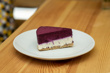 Fruit cheesecake on white plate in restaurant