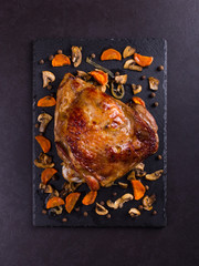 Thigh turkey baked in the oven with spices on black stone background. Healthy food. Thanksgiving...