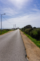 Fototapeta na wymiar Empty road at Ponte da Piedade lighthouse
