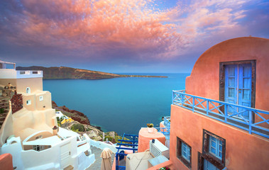 Fototapeta premium Oia town on Santorini island, Greece. Traditional and famous houses and churches with blue domes over the Caldera, Aegean sea