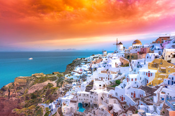 Oia town on Santorini island, Greece. Traditional and famous houses and churches with blue domes over the Caldera, Aegean sea