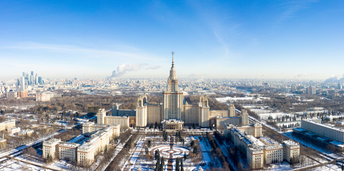 Naklejka premium Aerial view of Lomonosov Moscow State University (MGU, MSU) on Sparrow Hills, Moscow, Russia. Panorama of Moscow with the Main building of University. Beautiful Moscow view from above in winter.